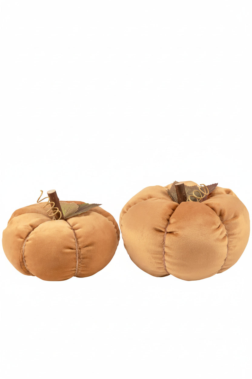 Two small plush pumpkin decorations in a warm tan color, each with a stitched seam, a faux stem, and a curled vine detail, shown on a plain white background.