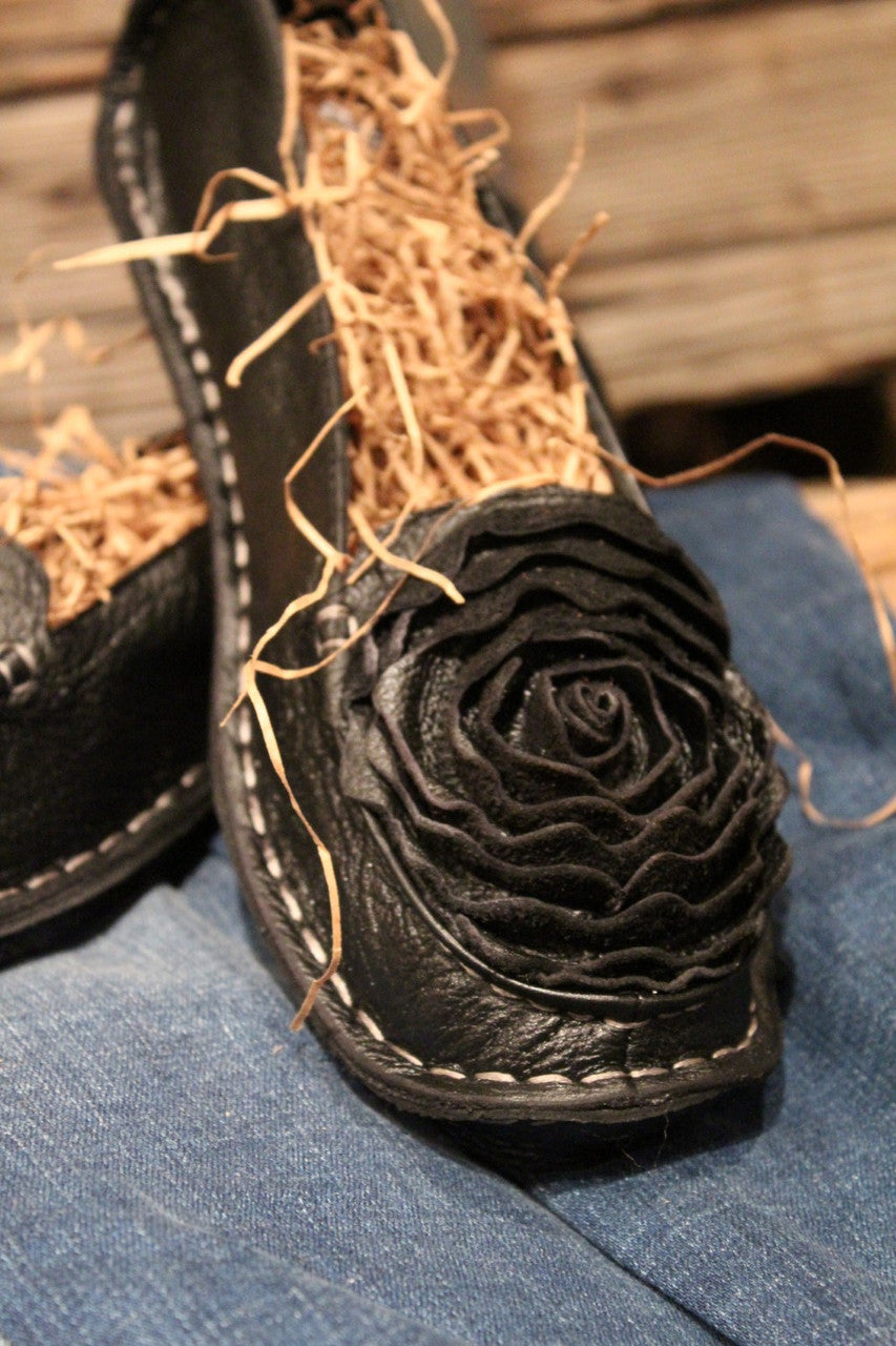 black leather loafer with flower rosette on toe
