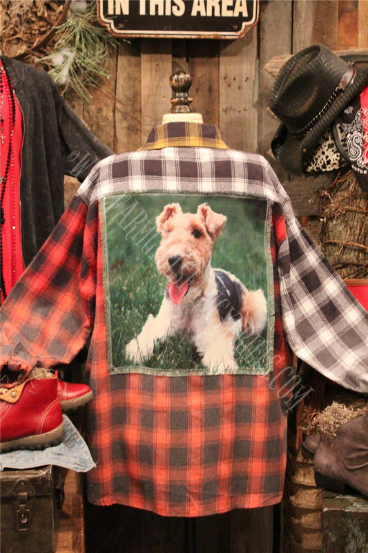 distressed flannel button up top with graphic featured on the back.