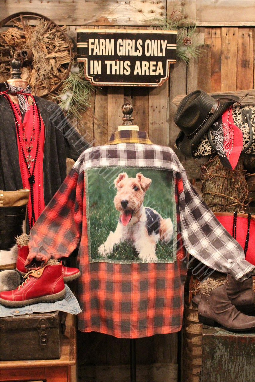 distressed flannel button up top with graphic featured on the back.
